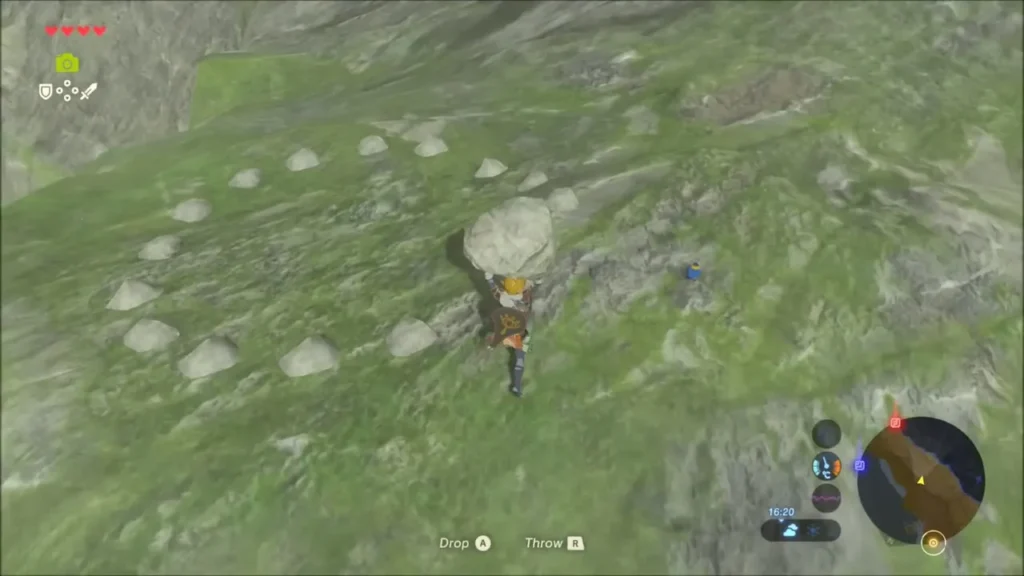 Link carrying the boulder toward a ring of small stones with a gap
