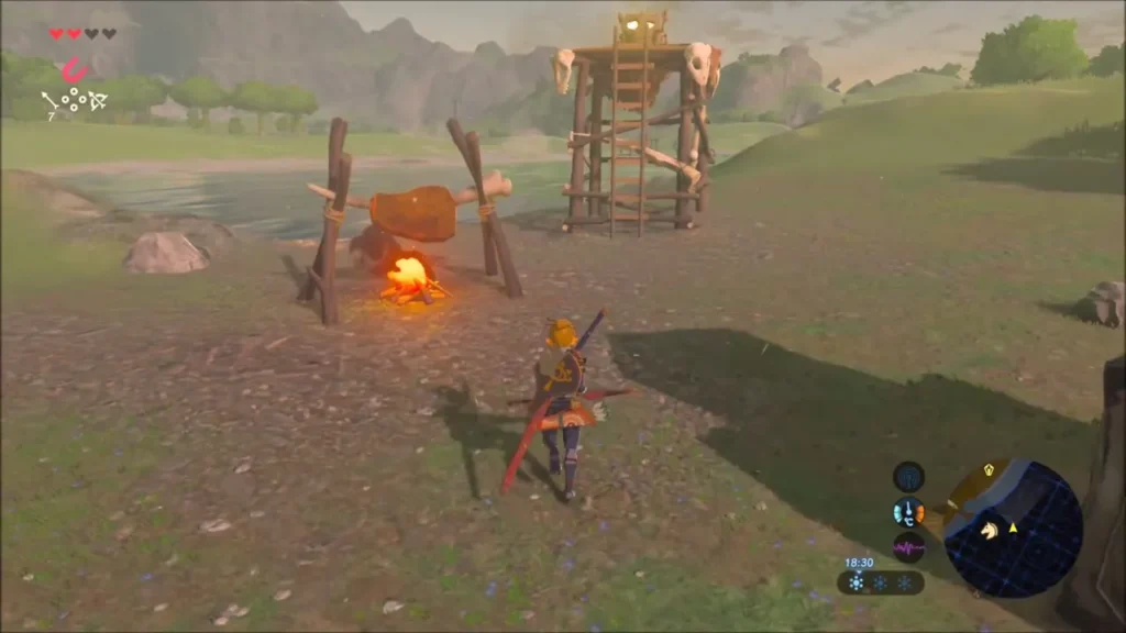 Link approaching a campfire with meat roasting on a spit beside a Bokoblin tower