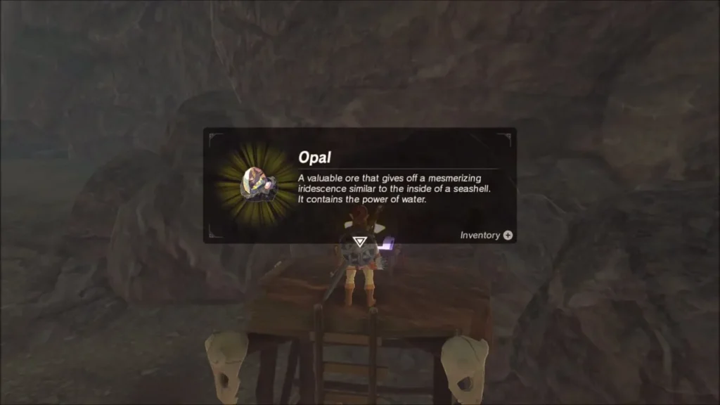Link on the lookout holding up an Opal from the camp chest