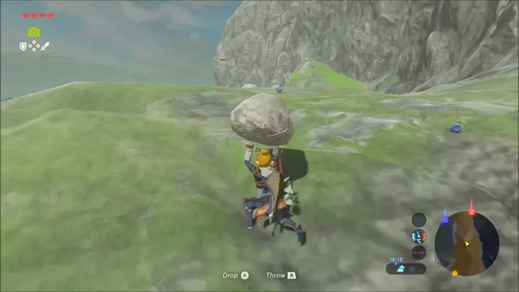 Link carrying a large boulder across a grassy slope