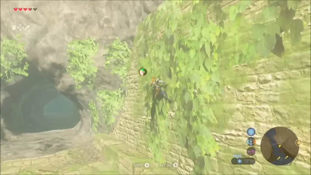Link climbing a vine-covered ruined wall beside a cave opening