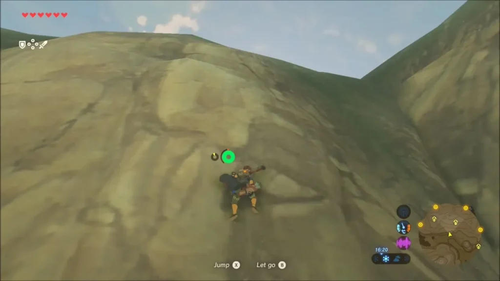 Link climbing the steep green slope