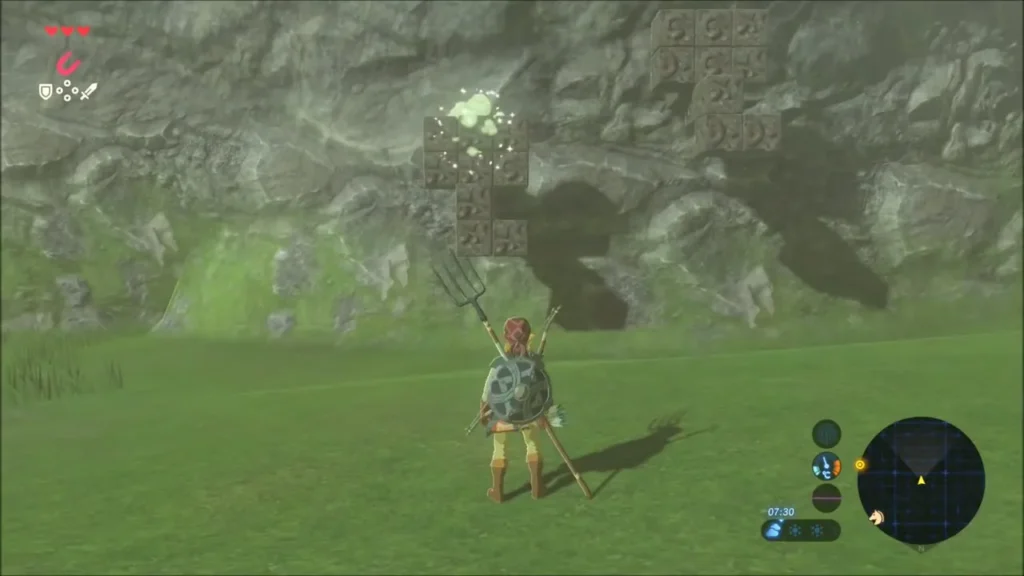 Stone cube wall on a grassy hillside with the metal block glowing