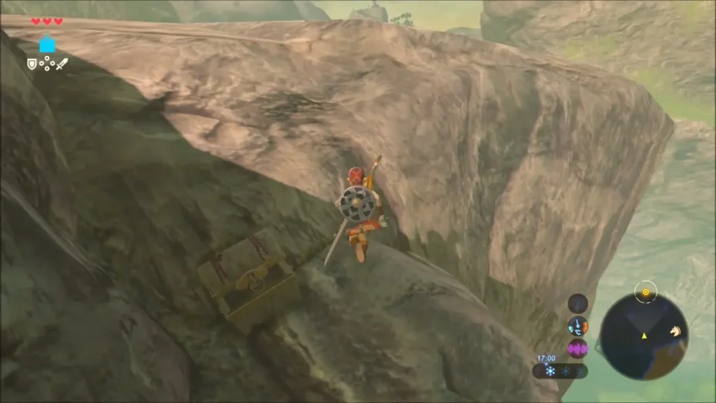 Link climbing beside a chest tucked into a cliff nook