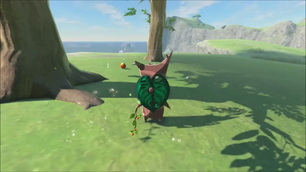 A Korok hiding behind an apple tree trunk on a grassy bluff