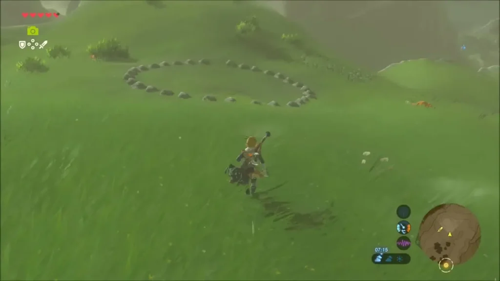 Link running up a grassy hill toward a ring of small stones
