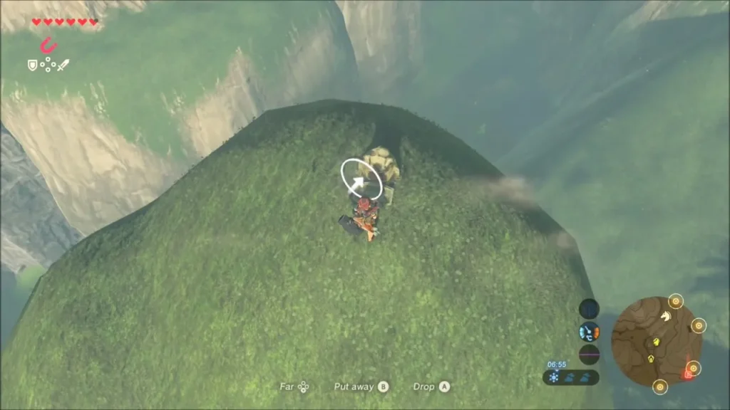 Link lifting the rock from the top of the hill