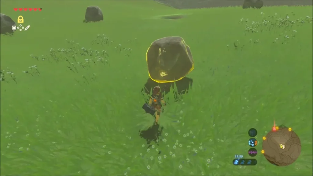 Link lifting a boulder in the open meadow