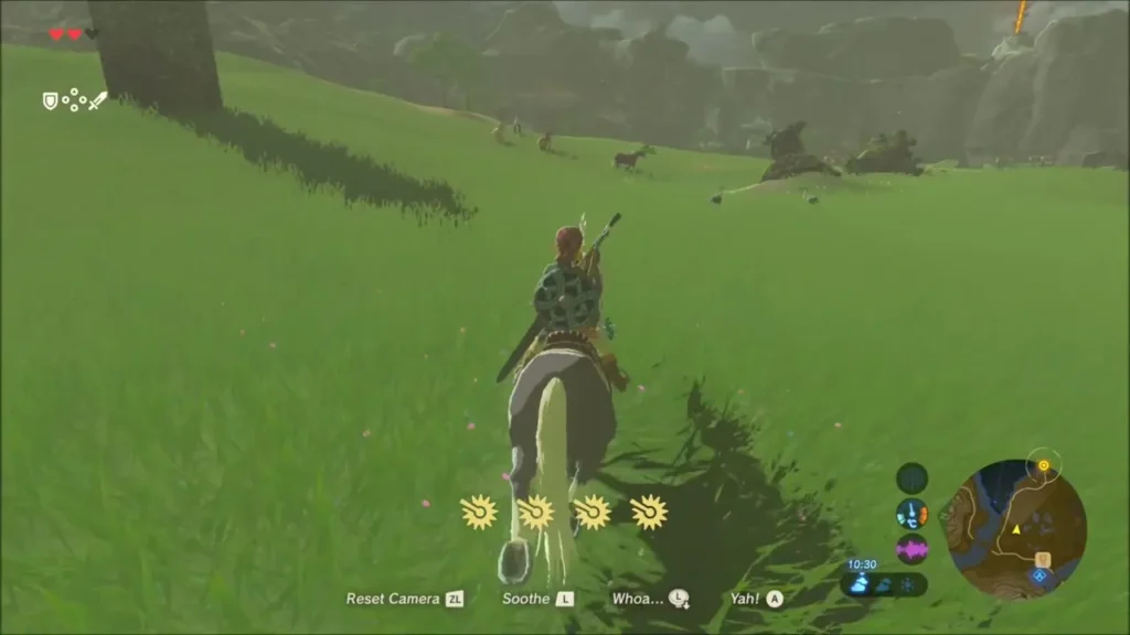 Link riding across the green field toward Fort Hateno