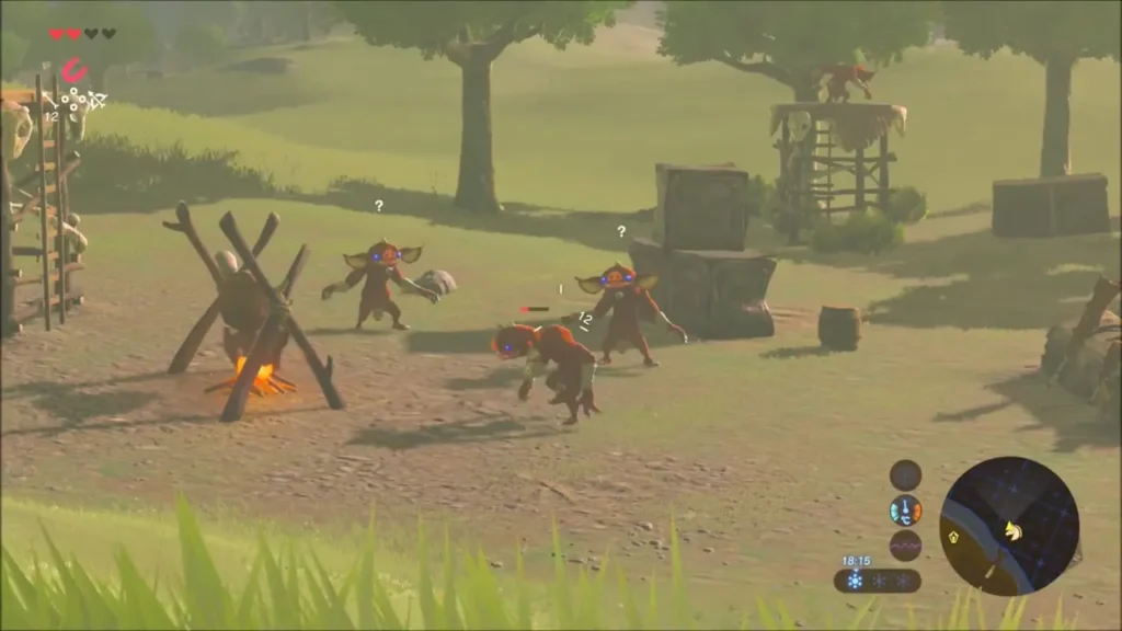 Bokoblins milling around a campfire and crates at a riverbank camp
