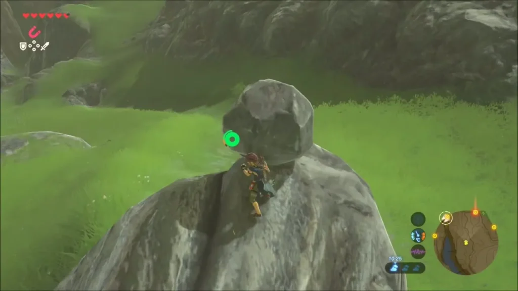 Link clinging to the boulder with a round rock resting on top
