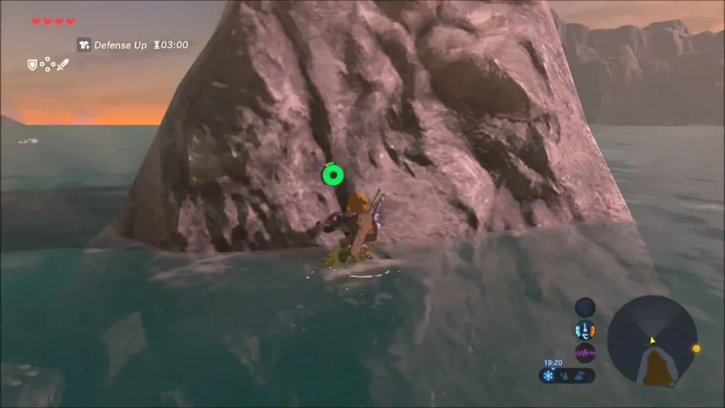 Link at the foot of a tall rock rising from the shallows at sunset