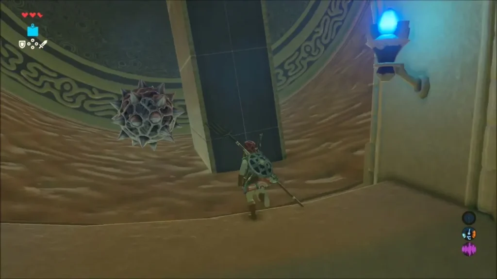 Link running up the turning wheel past a spiked ball