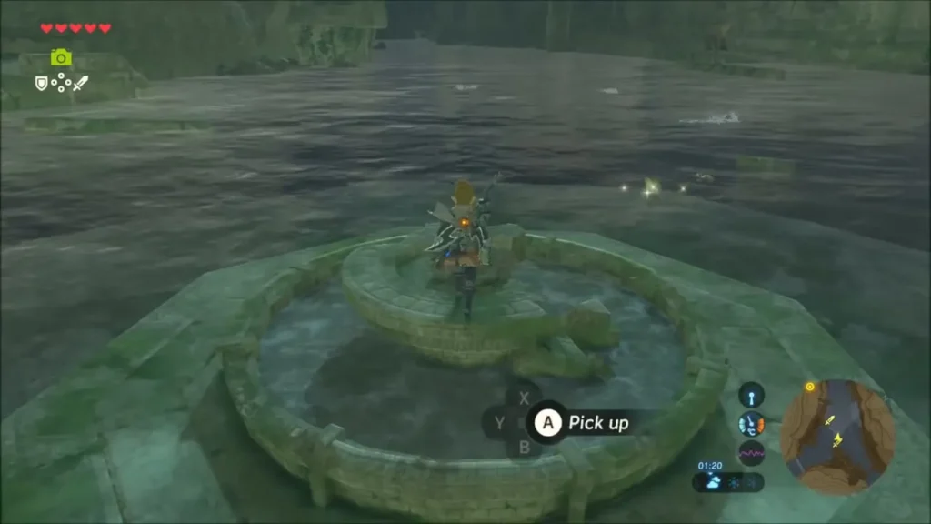 Link atop the platform at the round stone ring holding a rock to pick up