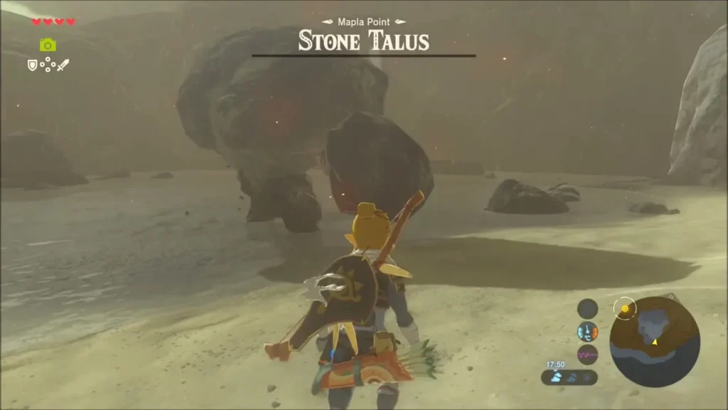 Link facing the nearly defeated Stone Talus on the shore