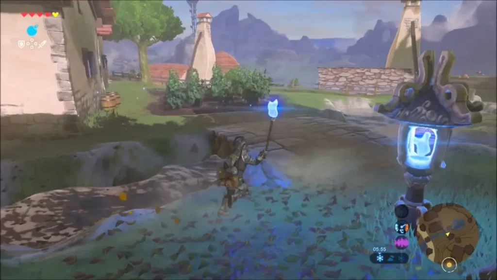 Link carrying the blue torch past a stone lantern in the village