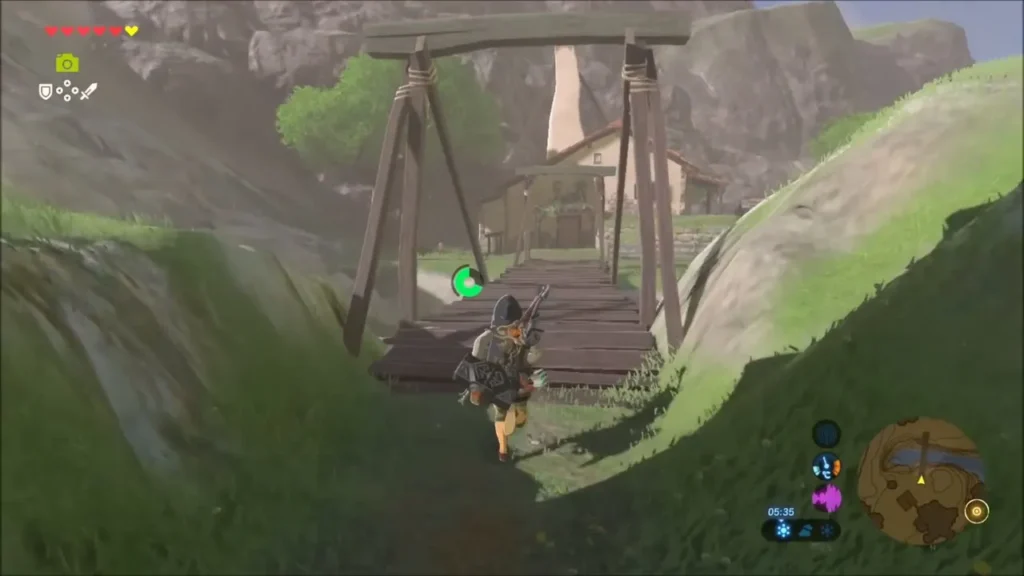Link running across the wooden bridge into Hateno Village