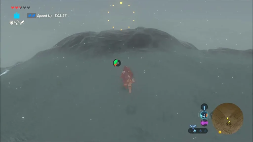 Ring of yellow lights hanging above a rounded snowy hilltop