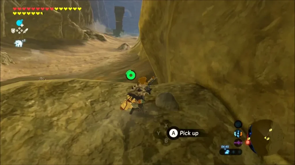 Link beside a loose stone at the foot of the canyon cliff with a pick up prompt Link beside a loose stone at the foot of the canyon cliff with a pick up prompt