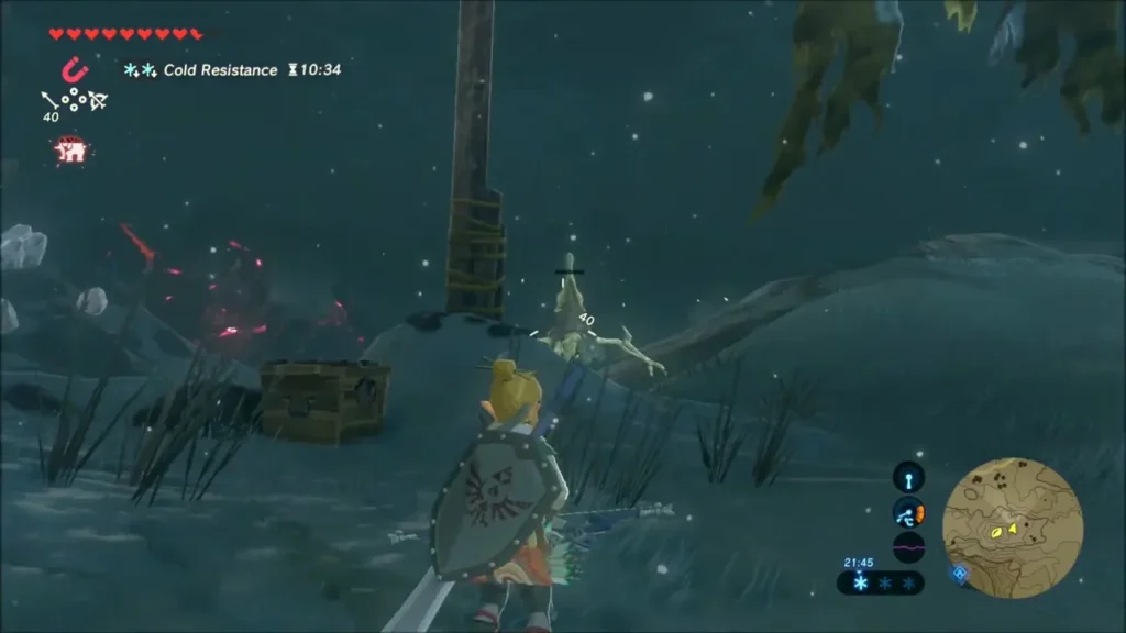A wooden chest in the snow beside a post as Link approaches A wooden chest in the snow beside a post as Link approaches