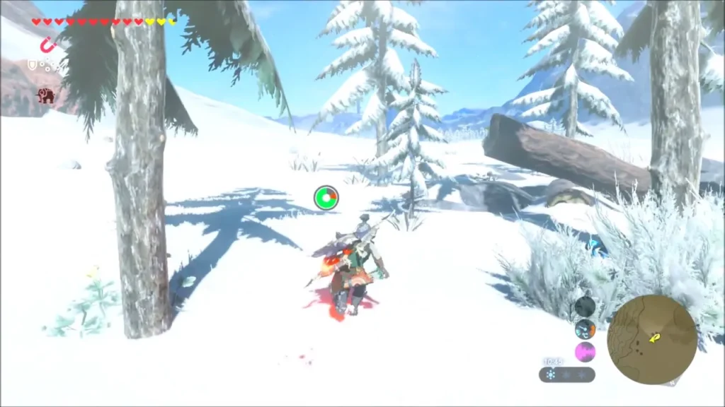 Link riding toward a fallen log among snow-laden pines Link riding toward a fallen log among snow-laden pines