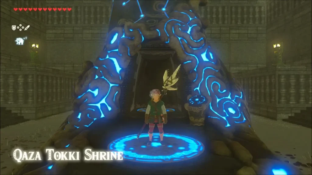 Link standing on the Qaza Tokki Shrine warp pad with the title Link standing on the Qaza Tokki Shrine warp pad with the title