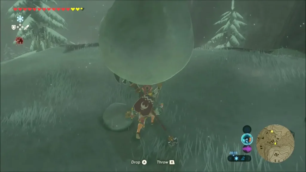 Link lifting a large snowball on the snowy hill, ready to push it down Link lifting a large snowball on the snowy hill, ready to push it down