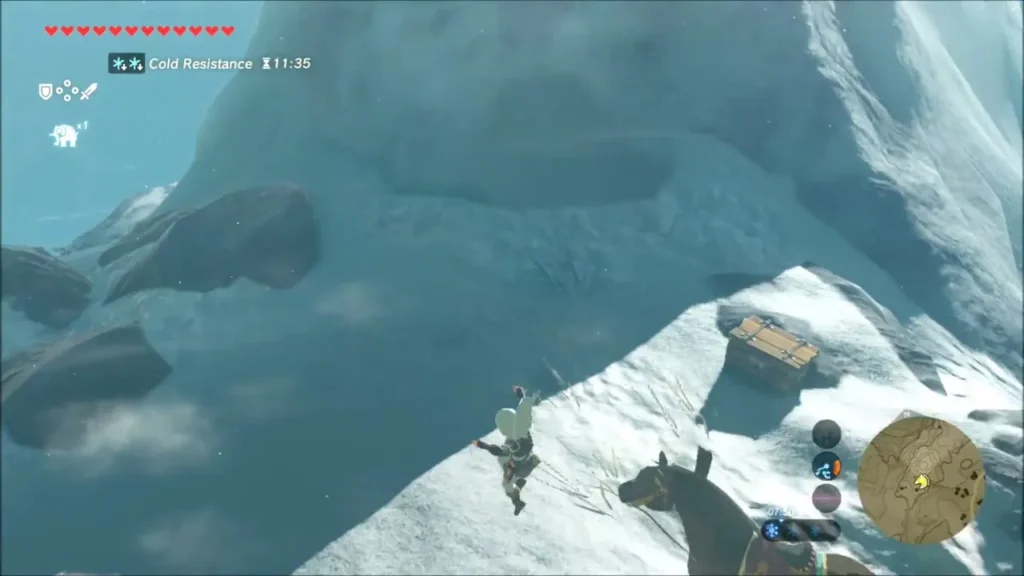 Link gliding down toward a chest on a snowy rise Link gliding down toward a chest on a snowy rise