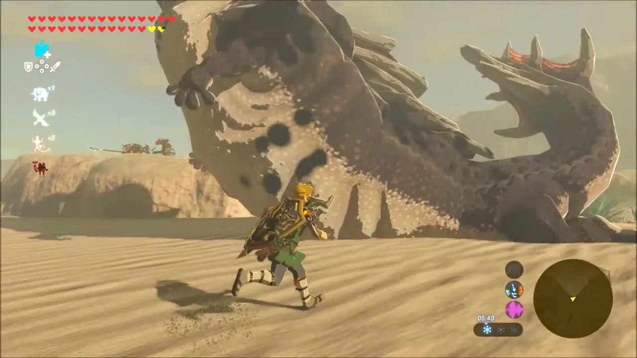 Link running across the sand as the huge Molduga rears up behind him Link running across the sand as the huge Molduga rears up behind him