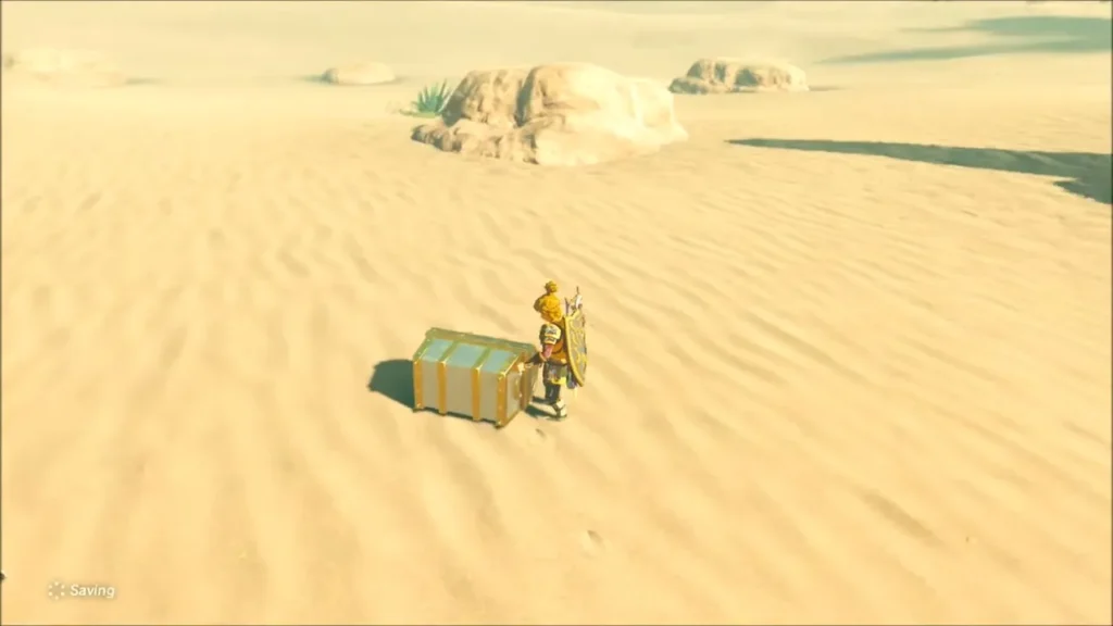 Link standing beside the Molduga chest in the Southern Oasis sand Link standing beside the Molduga chest in the Southern Oasis sand