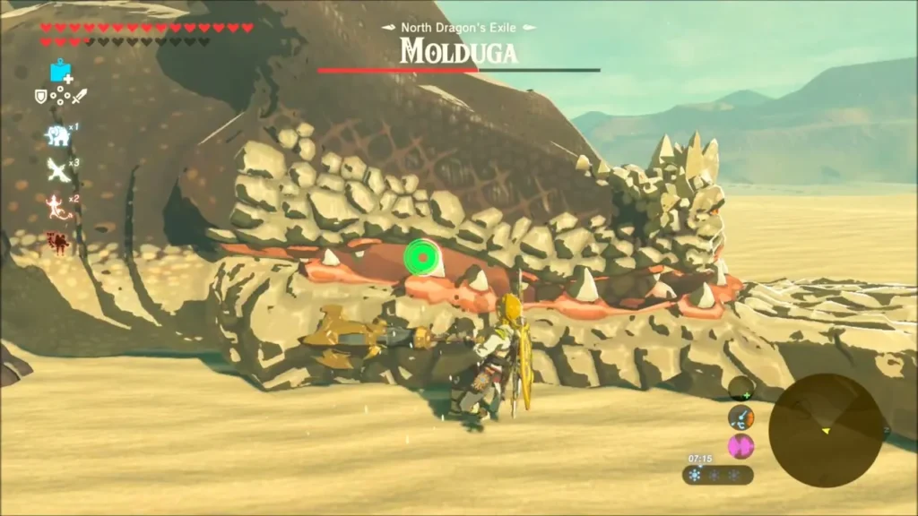 Link beside the huge Molduga on open desert sand Link beside the huge Molduga on open desert sand