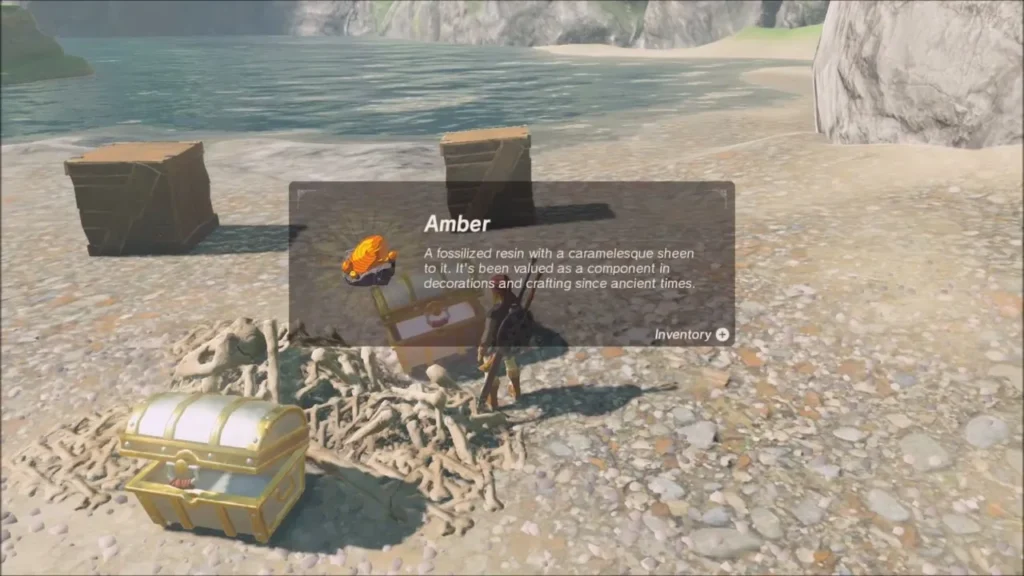 Link opening a chest in a pile of bones beside barrels, with the Amber item box showing Link opening a chest in a pile of bones beside barrels, with the Amber item box showing