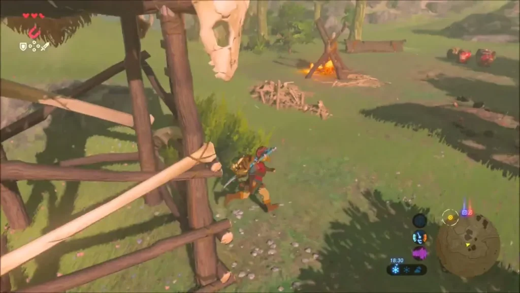 Link beside a bone-decorated wooden watchtower at the Bokoblin camp Link beside a bone-decorated wooden watchtower at the Bokoblin camp