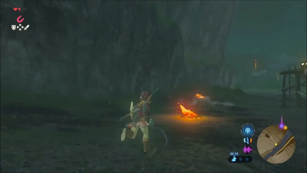Link running past a campfire toward a wooden lookout tower in the dark Link running past a campfire toward a wooden lookout tower in the dark