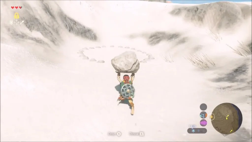 Link carrying a rock toward a ring of small stones in the snow Link carrying a rock toward a ring of small stones in the snow