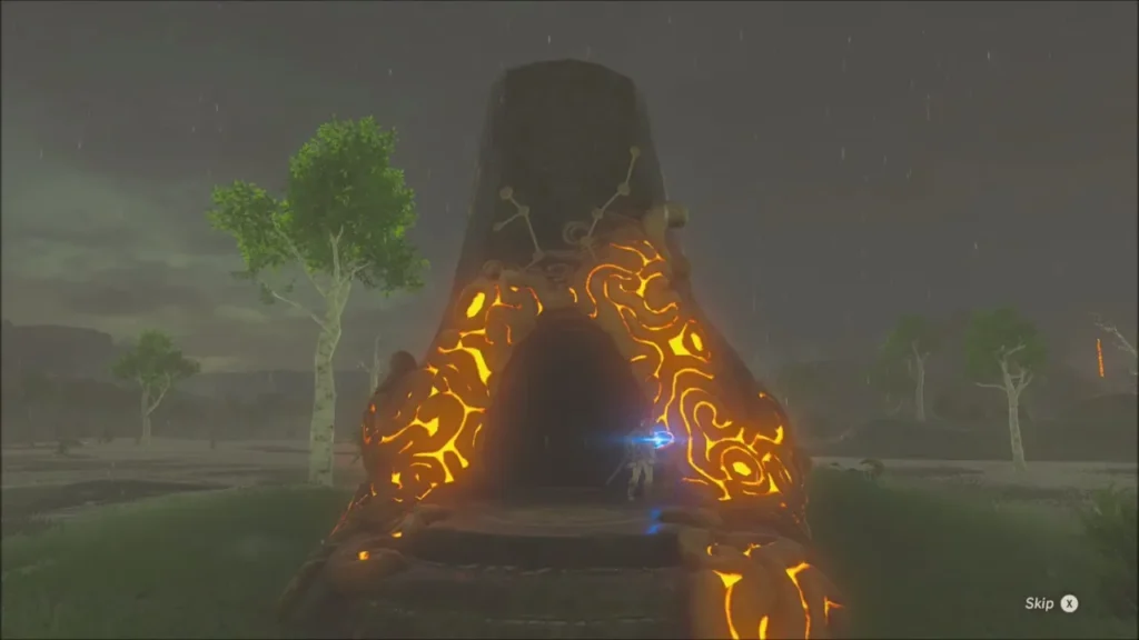 The glowing orange Daka Tuss Shrine entrance in the rain as Link approaches The glowing orange Daka Tuss Shrine entrance in the rain as Link approaches