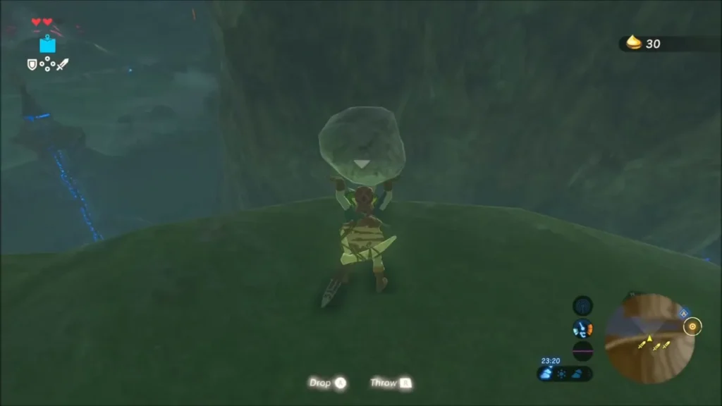 Link lifting a rock on a grassy knoll above the water Link lifting a rock on a grassy knoll above the water