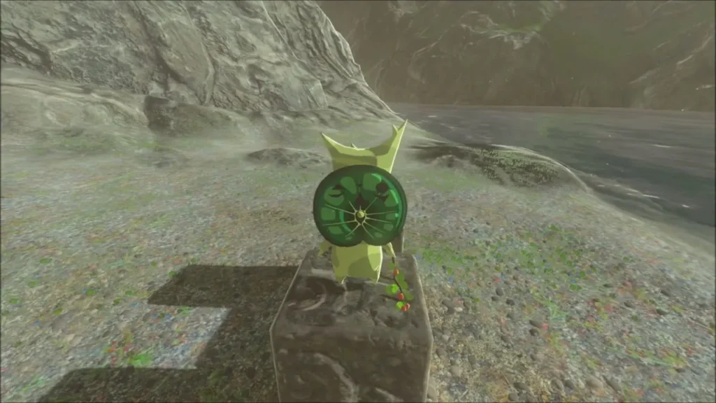 A Korok standing on a stone block on the gravel shore A Korok standing on a stone block on the gravel shore