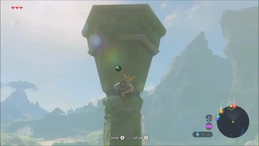 Link nearing the top of the pillar with mountains behind Link nearing the top of the pillar with mountains behind