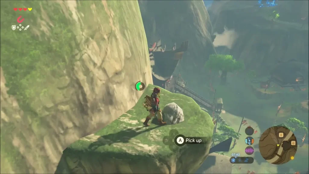 Link on the grassy ledge beside a rock with a Pick up prompt Link on the grassy ledge beside a rock with a Pick up prompt
