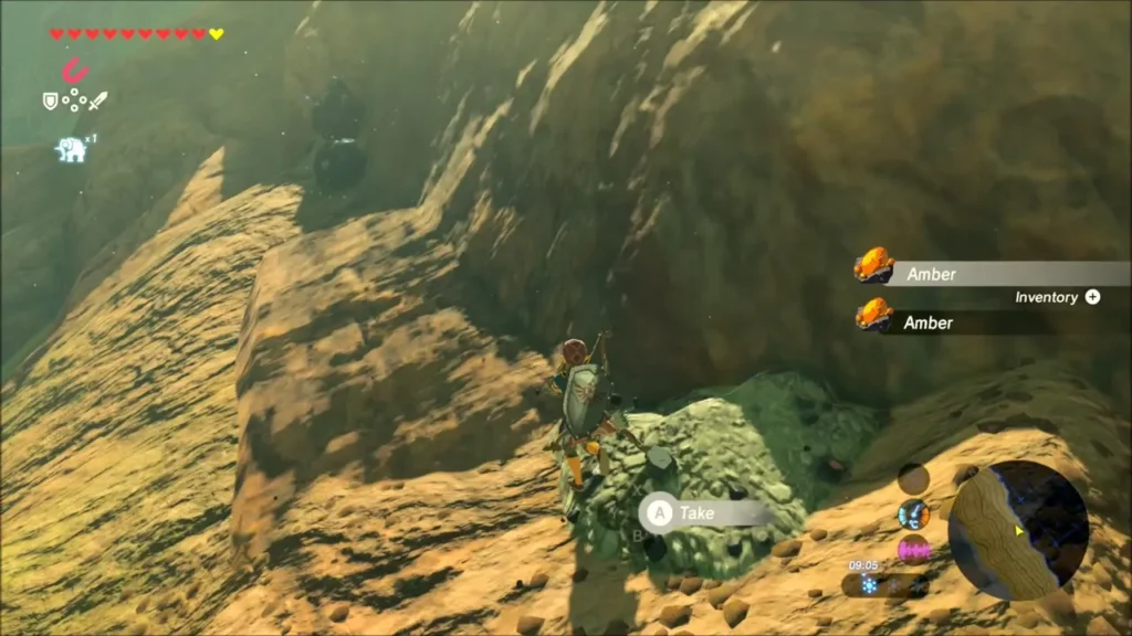 Link mining amber from a rock on a cliff face