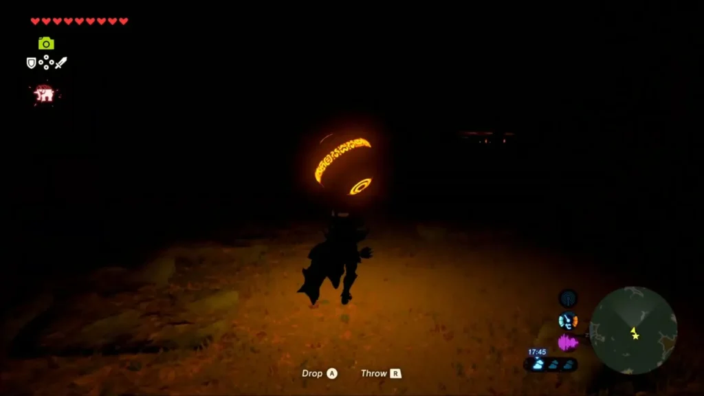 Link carrying the glowing orb through the dark