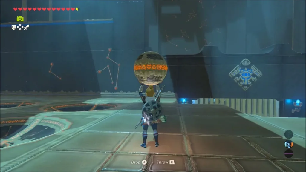 Link carrying a sphere across the shrine floor with constellations on the wall