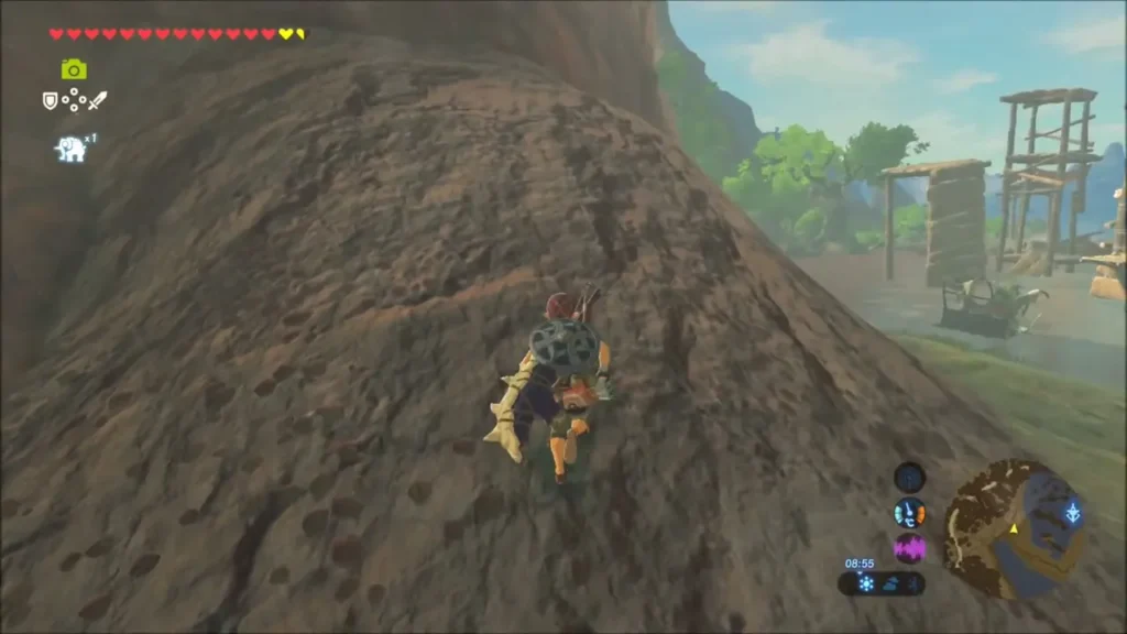Link climbing a red rock cliff above a wooden lookout