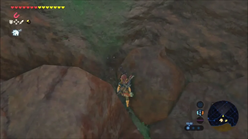 Link climbing a rock face above the gully