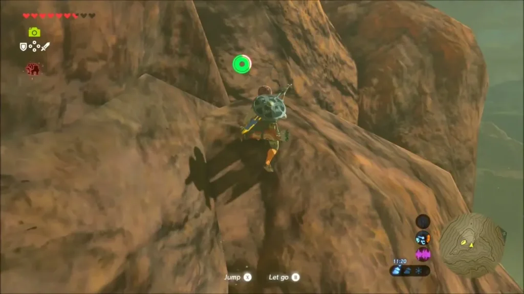 Link scaling the steep rocky peak toward the summit