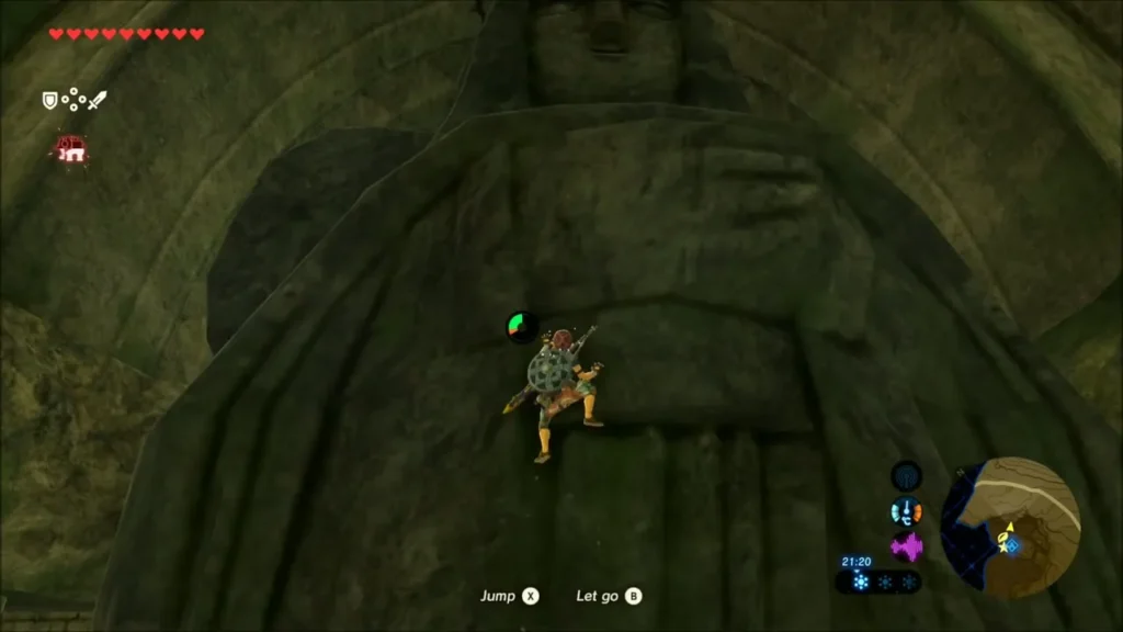 Link climbing the carved stone statue on the ruin wall