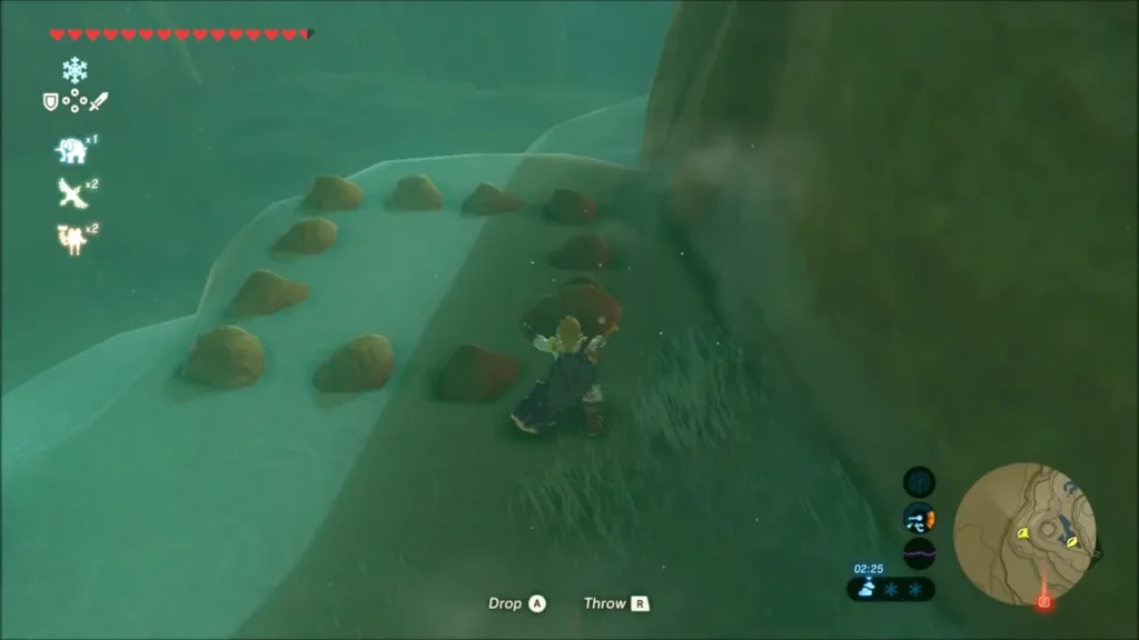 Link carrying a boulder toward a row of small brown stones on a snowy ledge Link carrying a boulder toward a row of small brown stones on a snowy ledge