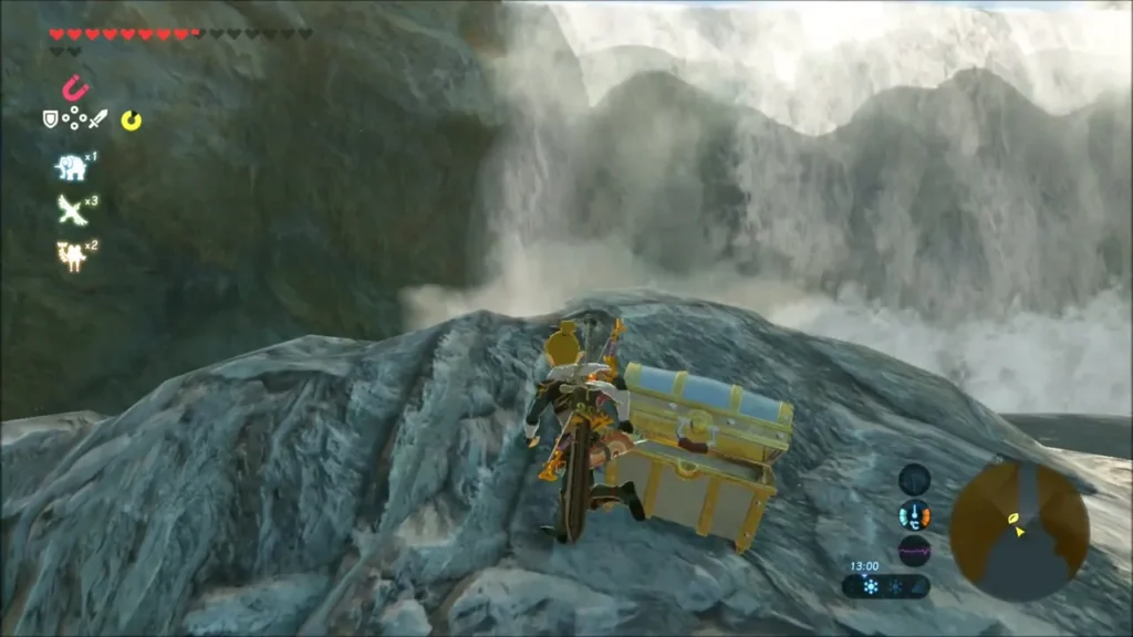 Link beside a chest on a rock in front of a waterfall Link beside a chest on a rock in front of a waterfall