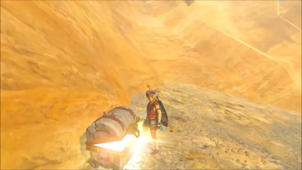Link beside an open glowing chest on a high sandy ledge Link beside an open glowing chest on a high sandy ledge